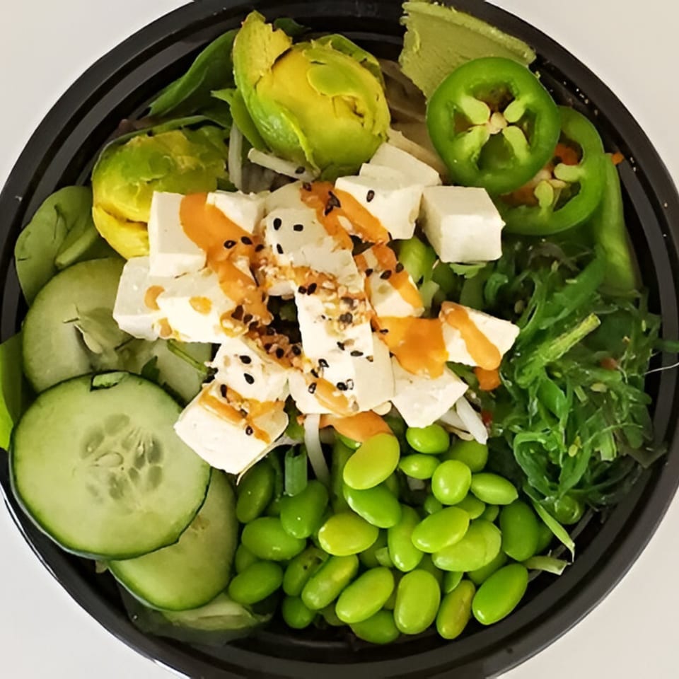A Grindz poke bowl with tofu, avocado, edamame, cucumber, seaweed, and jalapeños.